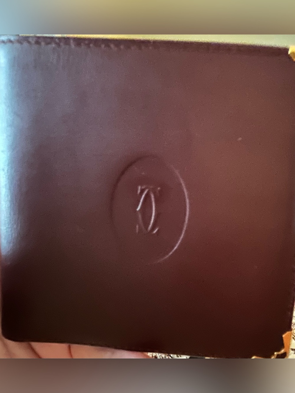 Cartier, Paris Burgundy Leather Embossed Monogram Bifold Wallet